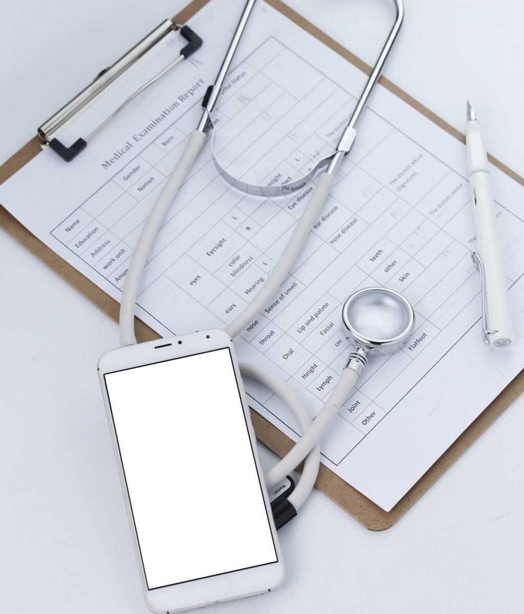 Mobile phone, stethoscope and chart file on the desktop (mobile medical, handheld doctor concepts)